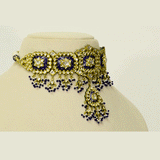 A traditional blue meena choker necklace and earring set adorned with hand-set diamond polki and strung with luminous pearls. Blending heritage enamel artistry with timeless elegance, it’s perfect for weddings and festive occasions. (KMNE3677)