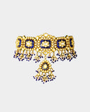 A traditional blue meena choker necklace and earring set adorned with hand-set diamond polki and strung with luminous pearls. Blending heritage enamel artistry with timeless elegance, it’s perfect for weddings and festive occasions. (KMNE3677)