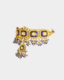 A traditional blue meena choker necklace and earring set adorned with hand-set diamond polki and strung with luminous pearls. Blending heritage enamel artistry with timeless elegance, it’s perfect for weddings and festive occasions. (KMNE3677)