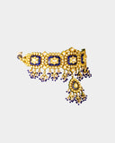 A traditional blue meena choker necklace and earring set adorned with hand-set diamond polki and strung with luminous pearls. Blending heritage enamel artistry with timeless elegance, it’s perfect for weddings and festive occasions. (KMNE3677)