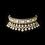 A regal blue enamelled choker set in gold, showcasing bold oversized polki diamonds framed with intricate detailing, finished with cascading South Sea pearl fringes and perfectly matched statement earrings for timeless grandeur. (KMNE3720)