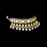 A regal blue enamelled choker set in gold, showcasing bold oversized polki diamonds framed with intricate detailing, finished with cascading South Sea pearl fringes and perfectly matched statement earrings for timeless grandeur. (KMNE3720)