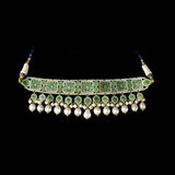 A regal blue enamelled choker set in gold, showcasing bold oversized polki diamonds framed with intricate detailing, finished with cascading South Sea pearl fringes and perfectly matched statement earrings for timeless grandeur. (KMNE3720)