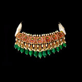 A majestic choker showcasing large polki diamonds set in striking green-enamelled gold, layered with intricate detailing, finished with cascading emerald drops and pearl fringes—opulent, bold, and exquisitely regal. (KMNE3724)
