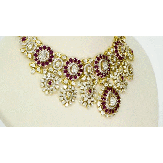 An exquisite fusion-style necklace set featuring sparkling Polki diamonds, brilliant round diamonds, and rich ruby accents, crafted in a bold heavy design to create a luxurious statement with timeless elegance and royal charm. (KMNE3727)