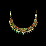 A stunning necklace set with gold and diamond polki, featuring green enamelled detailing, accented with emerald maniya drops and delicate pearls, creating a perfect blend of heritage elegance and vibrant sophistication. (KMNE3732)