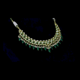 A stunning necklace set with gold and diamond polki, featuring green enamelled detailing, accented with emerald maniya drops and delicate pearls, creating a perfect blend of heritage elegance and vibrant sophistication. (KMNE3732)