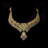 Grand statement necklace and earring pair featuring intricate peacock meenakari in vibrant hues, adorned with uncut diamond polki, highlighted by cascading multicolor beads with pearls, reflecting regal artistry and timeless bridal elegance. (KMNE3743)