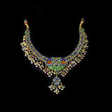 Grand statement necklace and earring pair featuring intricate peacock meenakari in vibrant hues, adorned with uncut diamond polki, highlighted by cascading multicolor beads with pearls, reflecting regal artistry and timeless bridal elegance. (KMNE3743)