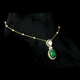 Diamond Polki & Emerald Pendant A graceful pendant featuring diamond polki, brilliant round diamonds, a striking emerald cabochon, and a delicate gold chain accented with elegant pearls for timeless sophistication.(KMNE3744)
