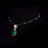 Diamond Polki & Emerald Pendant A graceful pendant featuring diamond polki, brilliant round diamonds, a striking emerald cabochon, and a delicate gold chain accented with elegant pearls for timeless sophistication.(KMNE3744)