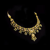 Exquisite gold necklace and earring set featuring uncut diamond polki, peacock meenakari in blue and green, and delicate pearls, blending royal heritage craftsmanship with timeless elegance for statement occasions. (KMNE3746)