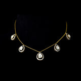Delicate pear-shaped diamond Polki gracefully framed by shimmering round diamonds, creating a timeless station necklace with effortless elegance and brilliance.(KMNE3775)
