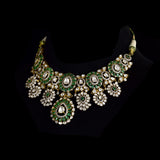 Inspired by royal artistry, this fusion necklace set combines dazzling diamond Polki, brilliant round diamonds, vibrant emeralds, and intricate floral craftsmanship for an effortlessly luxurious statement.(KMNE3782)