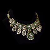 Inspired by royal artistry, this fusion necklace set combines dazzling diamond Polki, brilliant round diamonds, vibrant emeralds, and intricate floral craftsmanship for an effortlessly luxurious statement.(KMNE3782)