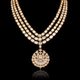 A masterpiece of traditional craftsmanship, this three-line Polki necklace with pendant and earrings radiates enduring elegance and royal charm.(KMNE3785)