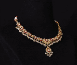 Grace every celebration with this handcrafted red meenakari necklace and earrings, featuring natural Polki diamonds and pearl accents.(KMNE3790)