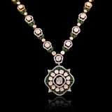 A striking fusion of heritage and modern glamour, this Polki diamond necklace set shines with brilliant diamonds and elegant green stones.(KMNE3791)