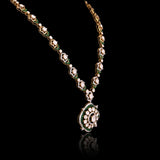 A striking fusion of heritage and modern glamour, this Polki diamond necklace set shines with brilliant diamonds and elegant green stones.(KMNE3791)