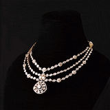 Three radiant strands of handcrafted Diamond Polki, highlighted by shimmering round diamonds and a statement pendant of timeless beauty.(KMNE3793)