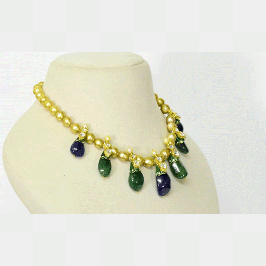 Radiant emerald and sapphire drops, accented with diamond polki, delicately strung with luminous South Sea pearls for timeless elegance and regal sophistication.(KMNE3796)