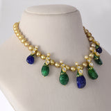 Radiant emerald and sapphire drops, accented with diamond polki, delicately strung with luminous South Sea pearls for timeless elegance and regal sophistication.(KMNE3796)