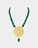 A traditional pendant adorned with hand-set polki diamonds, featuring intricate detailing and timeless elegance. Finished with rich emerald maniya stringing, it celebrates heritage craftsmanship with a touch of regal charm. (KMPE1325)