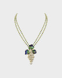 A pendant and earring set featuring diamond polki and round brilliant diamonds, accented with green and blue French enamel. Designed in a refined fusion style, it blends traditional artistry with a contemporary touch, ideal for festive occasions(KMPE1348)