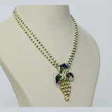 A pendant and earring set featuring diamond polki and round brilliant diamonds, accented with green and blue French enamel. Designed in a refined fusion style, it blends traditional artistry with a contemporary touch, ideal for festive occasions(KMPE1348)