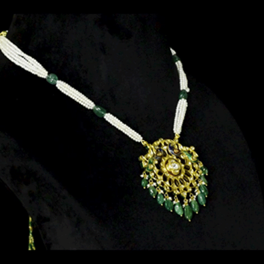 Graceful peacock pendant set adorned with diamond polki, delicately strung with pearls and emerald maniya, celebrating timeless heritage and refined elegance.(KMPE1364)