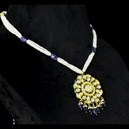 Blue Meenakari Pendant Set Elegant blue meenakari pendant set adorned with diamond polki, gracefully strung with pearls and sapphire maniya, celebrating timeless heritage and sophistication.(KMPE1372)