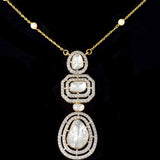 Featuring hand-set polki diamonds with shimmering diamond halos and a gold chain adorned with pearls, this pendant is a masterpiece of heritage luxury. (KMPE1384)