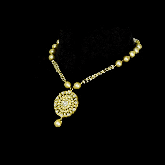 A timeless polki diamond pendant set crafted in gold, beautifully paired with pearl stringing and South Sea pearls, creating a graceful blend of heritage elegance and refined sophistication for every occasion. (KMPE1393)