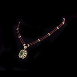 Fusion Emerald Pendant Set Contemporary pendant set featuring a vivid emerald, diamond polki and brilliant diamonds, gracefully strung with ruby and pearl in gold-wire chain for refined elegance.(KMPE1401)
