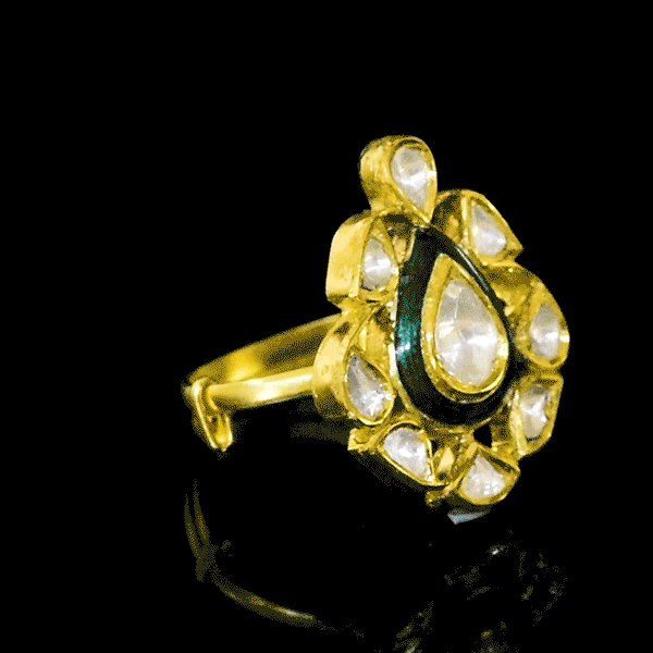 Grace your fingers with this green enameled ring, featuring uncut diamond Polki. Adjustable in size, it blends traditional charm with modern comfort for effortless elegance.(KMR0173)
