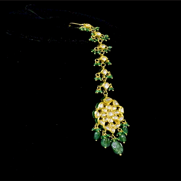 Elevate your elegance with this Ekposta Maangtika, featuring uncut diamond Polki and delicately strung with rich emerald beads.(KMTK0237)