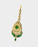 A regal maangtika adorned with diamond polki and a radiant emerald centre, finished with emerald and pearl stringing for timeless elegance and traditional bridal charm. (KMTK0243)
