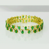 Emerald Diamond Bangle Elegant bangle adorned with vibrant pear-shaped emeralds and brilliant diamonds, beautifully arranged in a graceful floral pattern for timeless sophistication and luxury.(PGDB078)