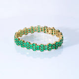 Vivid green emeralds arranged in a graceful flow, highlighted with subtle diamond brilliance for a sophisticated finish. (PGDBR063)