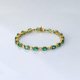 Graceful and elegant, this bracelet features vibrant emeralds paired with sparkling diamonds, creating a timeless design that adds beauty, charm, and a touch of luxury to any look.(PGDBR064)