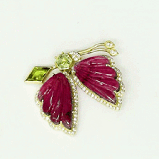 Butterfly Brooch Graceful butterfly brooch featuring carved pink tourmaline wings, vibrant peridot accents, and brilliant diamonds, celebrating nature-inspired elegance with contemporary sophistication.(PGDBRCH001)