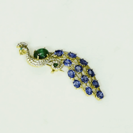 Royal Peacock Brooch Elegant peacock brooch adorned with vivid blue sapphires, rich emerald, and brilliant diamonds, beautifully capturing regal grace and timeless sophistication.(PGDBRCH002)
