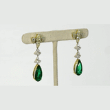 Featuring premium pear-shaped emeralds accented by shimmering diamonds, these statement earrings showcase refined craftsmanship, luxurious beauty, and a rich, graceful presence.(PGDE0439)