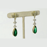 Featuring premium pear-shaped emeralds accented by shimmering diamonds, these statement earrings showcase refined craftsmanship, luxurious beauty, and a rich, graceful presence.(PGDE0439)