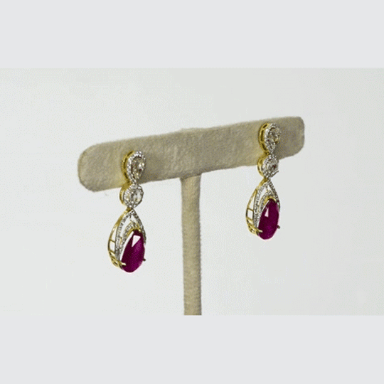 Graceful ruby pear paired with sparkling diamonds create elegant earrings that radiate beauty, brilliance, and timeless sophistication.(PGDE0442)