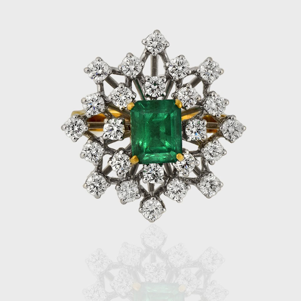 Ring, a captivating union of elegance and luxury, adorned with a stunning Emerald embraced by shimmering Diamonds.(PGDR0416)