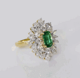 Stunning ring with vivid oval emerald of exceptional color and quality, accented by sparkling diamonds—elegant and timeless for every occasion.(PGDR0459)