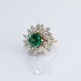 A fine emerald centerpiece surrounded by sparkling diamonds, creating a graceful ring that radiates timeless elegance and brilliance.(PGDR0460)