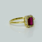 Celebrate timeless beauty with an emerald-cut pink tourmaline ring, gracefully highlighted by a shimmering halo of brilliant round diamonds.(PGDR0472)
