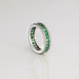 A timeless eternity band showcasing vivid channel-set emeralds, framed by brilliant round diamonds for an elegant statement of everlasting luxury.(PGDR0510)
